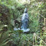 Kwan Yin, Chinese goddess of mercy and compassion. Statue of Kwan Yin in the grounds of Greenway House.